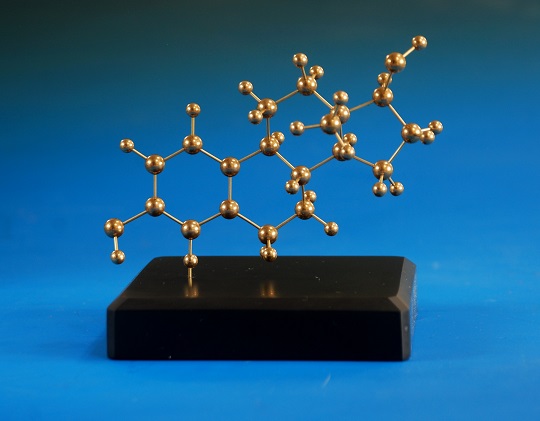 A brass model of estradiol on a polished slate base