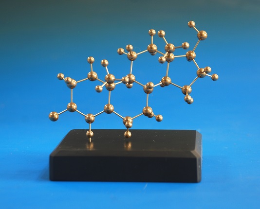 A molecular model of testosterone made in brass on a slate stone base