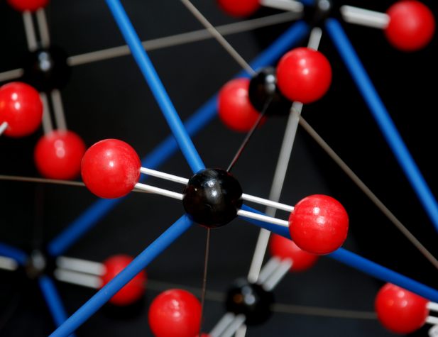 A carbon dioxide molecule in a large model of the CO2 structure, showing the double bonds