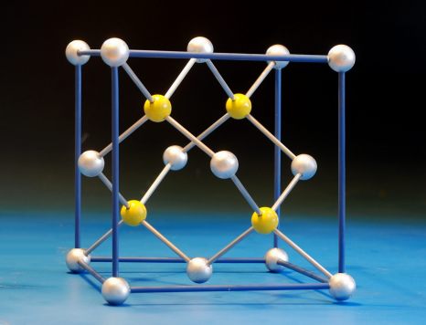 A large crystal structure model of sphalerite, ZnS, with a highlighted unit cell, made with wooden balls and aluminium rods