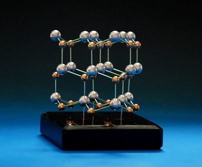 Crystal structure model of Gallium nitride made with metal balls and anodised aluminium rods on a granite base 