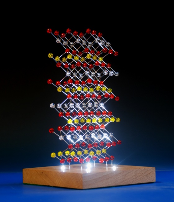 A custom built illuminated crystal structure model of lithium cobalt oxide on a wood base